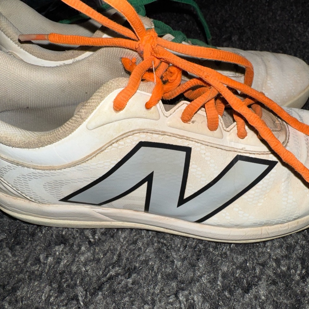 White New Balance girls softball cleats.